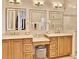 Elegant bathroom with double sinks and light wood cabinets at 3222 W Empedrado St, Tampa, FL 33629