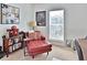 Relaxing bedroom with a red chaise lounge and large window at 3222 W Empedrado St, Tampa, FL 33629