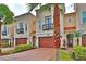 Three-story townhome community featuring attached garages and manicured landscaping at 3222 W Empedrado St, Tampa, FL 33629