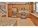 Well-equipped kitchen featuring granite countertops and wood cabinetry at 3222 W Empedrado St, Tampa, FL 33629