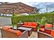 Relaxing patio area with comfortable wicker furniture and umbrella at 3222 W Empedrado St, Tampa, FL 33629