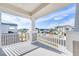 Charming balcony showcasing neighborhood views and manicured landscaping from an elevated vantage point at 33945 Landsman Loop, Wesley Chapel, FL 33543