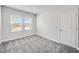 Light-filled bedroom with plush gray carpet and large windows at 33945 Landsman Loop, Wesley Chapel, FL 33543