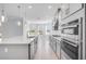 Bright kitchen with stainless steel appliances, a large island, and stylish pendant lighting at 33945 Landsman Loop, Wesley Chapel, FL 33543