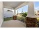 Covered patio featuring stone accents and white railing with scenic neighborhood views at 33945 Landsman Loop, Wesley Chapel, FL 33543