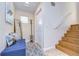 Bright entryway with built-in bench, coat rack, and staircase at 3405 W Swann Ave # 1, Tampa, FL 33609