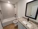 Bathroom with granite vanity and tiled shower at 3418 Eagle Pass St, North Port, FL 34286