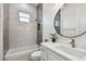 Modern bathroom with a white vanity, a large mirror, and a bathtub at 3469 17Th S Ave, St Petersburg, FL 33711