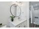 Stylish bathroom featuring a round mirror and white vanity at 3469 17Th S Ave, St Petersburg, FL 33711