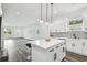 Modern white kitchen with island, stainless steel appliances, and white shaker cabinets at 3469 17Th S Ave, St Petersburg, FL 33711