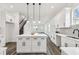 Modern white kitchen with island, stainless steel appliances, and white shaker cabinets at 3469 17Th S Ave, St Petersburg, FL 33711