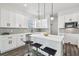 Modern white kitchen with island, stainless steel appliances, and white shaker cabinets at 3469 17Th S Ave, St Petersburg, FL 33711