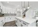 Modern white kitchen with island, stainless steel appliances, and white shaker cabinets at 3469 17Th S Ave, St Petersburg, FL 33711