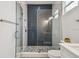 Modern walk-in shower with geometric tile and glass door at 3469 17Th S Ave, St Petersburg, FL 33711