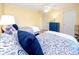 Bright bedroom with twin beds, dresser, and blue bedding at 3475 41St S Ter # 215, St Petersburg, FL 33711