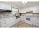 Updated kitchen featuring white cabinets and a farmhouse sink at 3475 41St S Ter # 215, St Petersburg, FL 33711