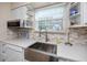 Bright kitchen boasts a farmhouse sink and stylish backsplash at 3475 41St S Ter # 215, St Petersburg, FL 33711