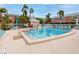 Community pool with lounge chairs and palm trees at 3475 41St S Ter # 215, St Petersburg, FL 33711