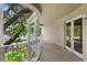 Private balcony overlooks tree-lined street and water at 3507 Bayshore Blvd # 102, Tampa, FL 33629