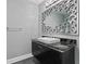 Stylish bathroom with a dark vanity, granite countertop, and ornate mirror at 3507 Bayshore Blvd # 102, Tampa, FL 33629