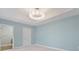 Serene bedroom with light blue walls, plush carpeting, and a large chandelier at 3507 Bayshore Blvd # 102, Tampa, FL 33629