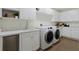 Modern laundry room with white cabinets and updated appliances at 3507 Bayshore Blvd # 102, Tampa, FL 33629