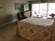 Main bedroom with a comfortable bed, access to balcony and water view at 3717 46Th S Ave # 2, St Petersburg, FL 33711