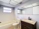 Bathroom with white tiled walls, vanity with dark cabinets, and combined tub and shower at 4024 Jib Sail Ct, New Port Richey, FL 34652