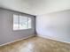 This bedroom features neutral walls, tile floors, and a bright window at 4024 Jib Sail Ct, New Port Richey, FL 34652