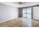 Bedroom with tile flooring and sliding glass doors that lead to the pool at 4024 Jib Sail Ct, New Port Richey, FL 34652