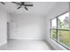 Spacious bedroom with large window and ceiling fan at 425 Rose Apple Cir, Port Charlotte, FL 33954