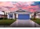 Newly constructed home with a blue garage door and landscaping at 425 Rose Apple Cir, Port Charlotte, FL 33954