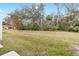 Large grassy backyard with mature trees and lush landscaping at 4409 Winding River Way, Land O Lakes, FL 34639