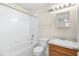 Clean bathroom with tub, toilet and wood vanity at 4409 Winding River Way, Land O Lakes, FL 34639