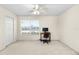 Bedroom with ceiling fan, window, and workspace at 4409 Winding River Way, Land O Lakes, FL 34639