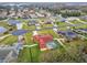 Expansive aerial view of a neighborhood featuring mature landscaping, a pool and well-maintained lawns at 4534 Cozzo Dr, Land O Lakes, FL 34639