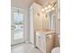 Bright bathroom featuring a vanity with marble countertop, and a door leading to the pool area at 4534 Cozzo Dr, Land O Lakes, FL 34639