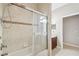 Bright bathroom featuring a bathtub with a shower, tiled walls, and vanity at 4534 Cozzo Dr, Land O Lakes, FL 34639