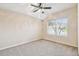 Comfortable bedroom featuring neutral carpeting, bright window, and calming walls at 4534 Cozzo Dr, Land O Lakes, FL 34639