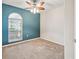 A tranquil bedroom featuring carpet, ceiling fan, window and accent wall at 4534 Cozzo Dr, Land O Lakes, FL 34639