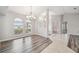 Inviting dining room with wood floors, lots of natural light and decorative chandelier at 4534 Cozzo Dr, Land O Lakes, FL 34639