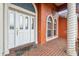 Close-up of the front entrance with an ornate door, decorative columns, and brick walkway at 4534 Cozzo Dr, Land O Lakes, FL 34639