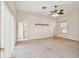 Spacious primary bedroom with a ceiling fan, bathroom and doorway, cozy carpet at 4534 Cozzo Dr, Land O Lakes, FL 34639