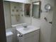 Bathroom with single sink vanity and mirrored medicine cabinets at 4575 Cove Cir # 904, Madeira Beach, FL 33708