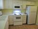 White kitchen with built-in microwave and range at 4575 Cove Cir # 904, Madeira Beach, FL 33708