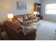 Living room with brown leather sectional sofa and coffee table at 4575 Cove Cir # 904, Madeira Beach, FL 33708