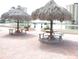 Relaxing patio area with thatched umbrellas at 4575 Cove Cir # 904, Madeira Beach, FL 33708