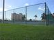 Tennis courts with chain link fence and grassy area at 4575 Cove Cir # 904, Madeira Beach, FL 33708