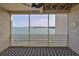 Waterfront balcony with screened enclosure and fish patterned rug at 4625 Mirabella Ct, St Pete Beach, FL 33706