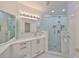 Modern bathroom with a walk-in shower and white vanity at 4625 Mirabella Ct, St Pete Beach, FL 33706